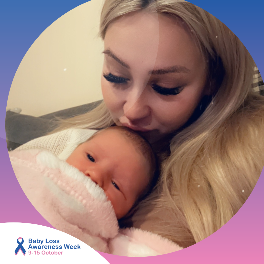 Charlotte is kissing Stormi on the head, as Stormi lies awake on her chest